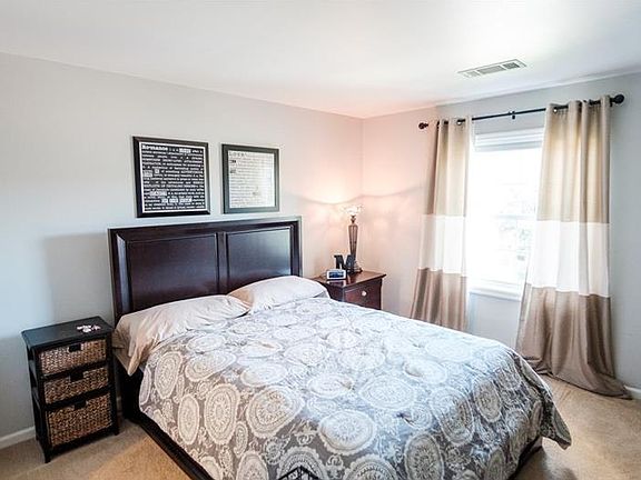 bright bedroom with walk-in closet