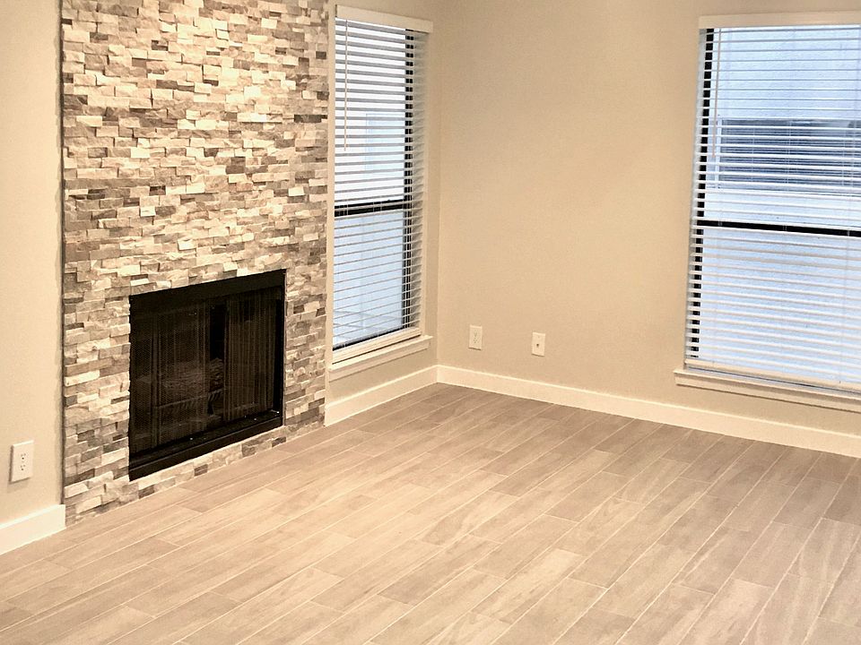Living room with beautifully decorated fireplace and natural light through windows