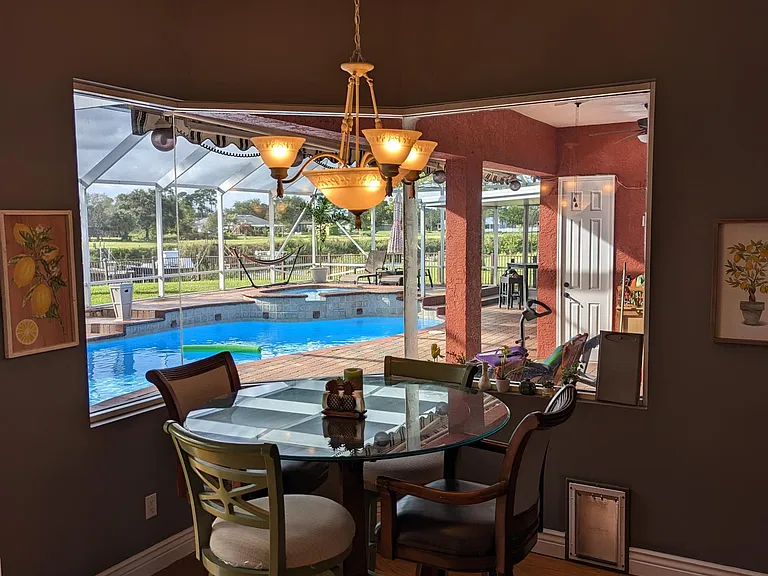 Dining nook. Designed for 4 but can accommodate 6 with the additional chairs that are available. If you have pets, note the lockable dog door. Another option for taking in meals or snacks with a pool, sunrise or sunset view.