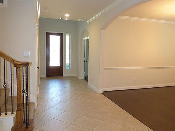 Tile floors welcome you into this lovely home and usher you past the study, a hallway to a secondary bedroom with an ensuite bath and the formal dining room.