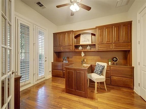 French doors open to the dedicated study with built-ins and front porch access.