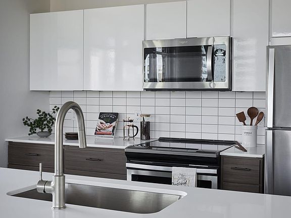 Large kitchen with island and stainless steel appliances