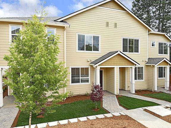 The charming Blackberry townhome at Harts Crossing includes a welcoming community landscaping.