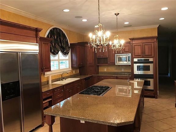 Elegant kitchen with ice maker and wine cooler.