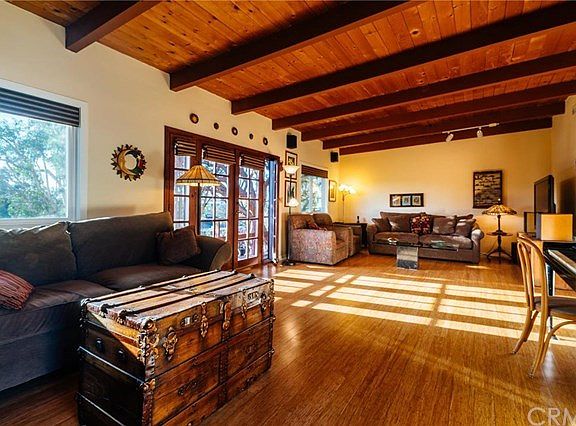 Large expansive living/family room with beautiful treetop and sunset views
