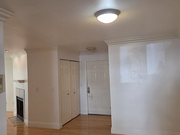 View of the entrance to the unit. Behind the double doors is a spacious storage, where the washer-dryer is located.