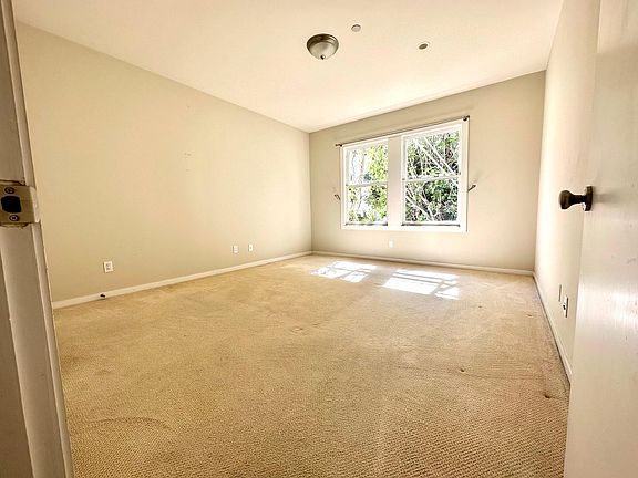 Large light filled master bedroom overlooking garden with 2 closets