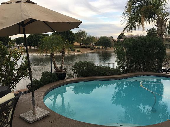 Resort style patio with view of lake and park beyond