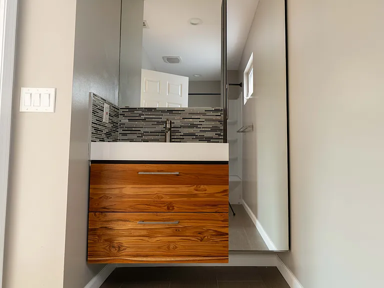 Upstairs bathroom with teak wood drawers.
