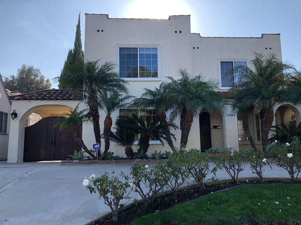 2-story Spanish home on tree-lined street in a walkable neighborhood.
