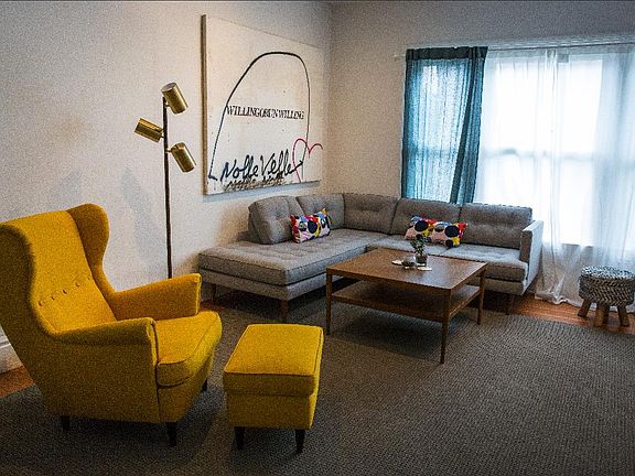 View of living room. Large carpet and some curtains included throughout the house. Most of these photos are from when it was a short term rental in 2018. In general, furnishings are not included, unless noted otherwise.