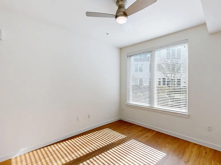 Spacious apartment Bedroom with Wood-Style Flooring.
