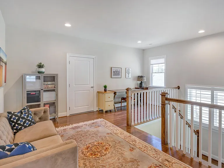 Landing, with office nook, connecting to unfinished storage space.