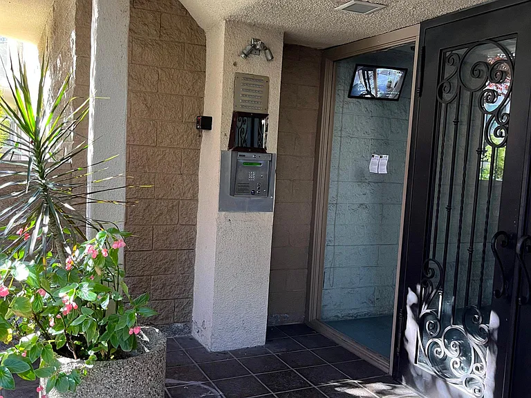 Serene building entry with controlled access.