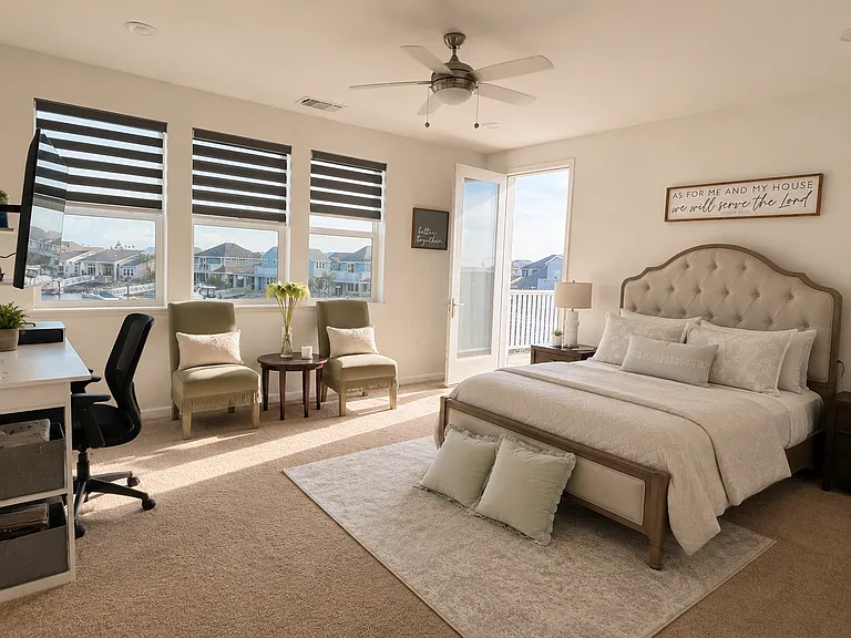 Mayster bedroom with door leading to balcony