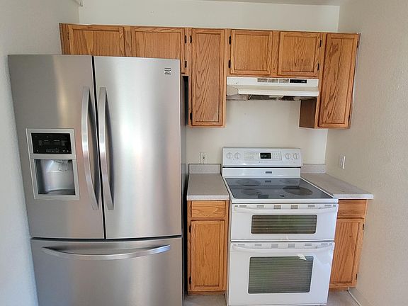 Dual oven with glass cooktop. The refrigerator does not have a hookup for ice or water, but has a large capacity for frozen and food items.