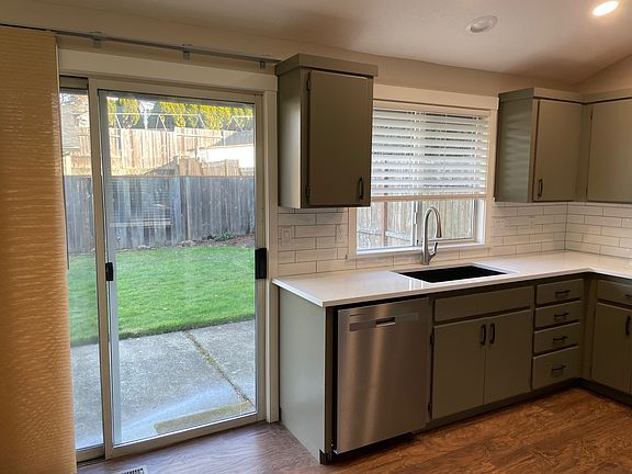 Kitchen w/ slider to fully fenced backyard