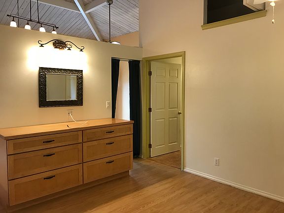 Bedroom dresser with bathroom on the right