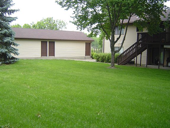 Kitchen facing green lawn with mature trees