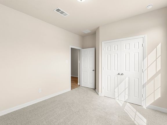 An additional view of the third bedroom and closet