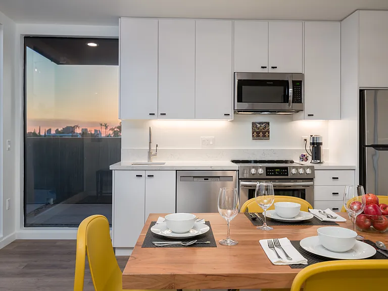 Kitchen with dishwasher, microwave, fridge, oven. Wood look plank floors throughout upper level.