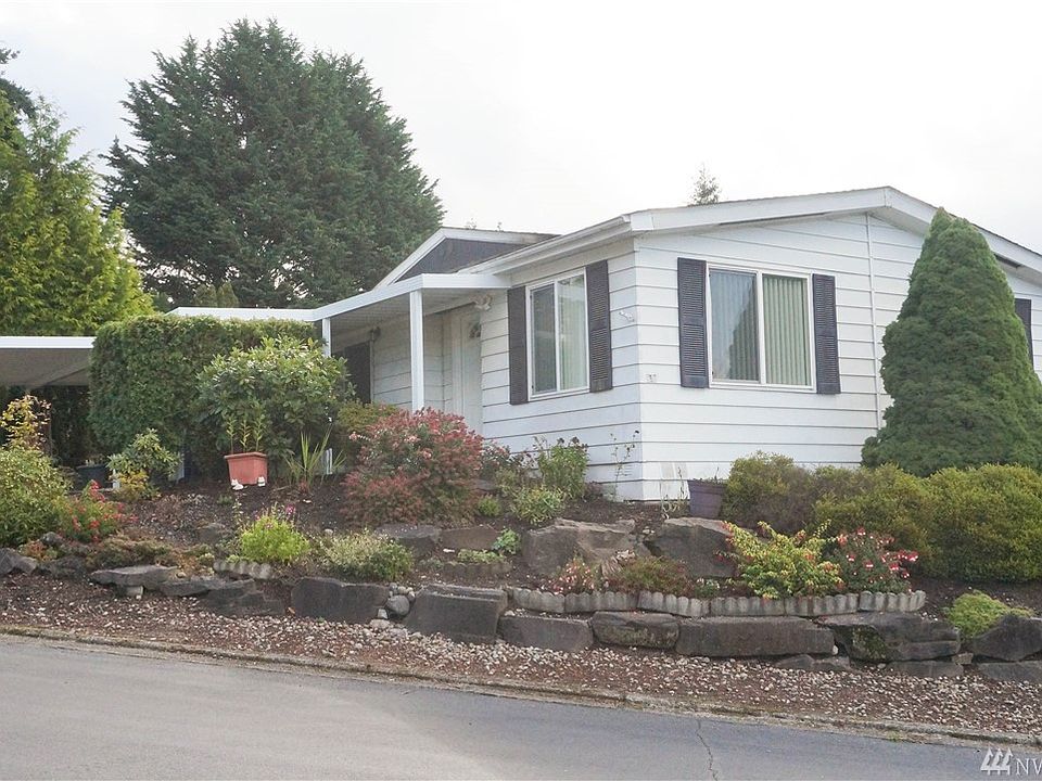 The home is located on a corner lot of a cul de sac with a lovely landscaped rockery.