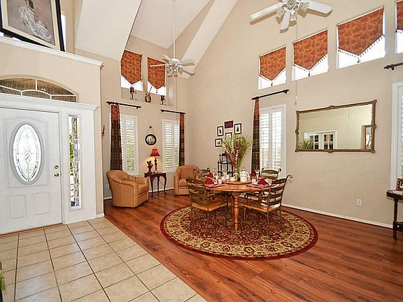 Front door with oval glass insert opens to a warm and inviting home. Architectural interest is creat