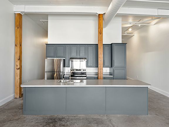 Kitchen with bar and open to living room.
