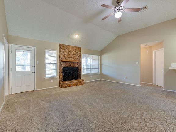 Living Room with Vaulted Ceiling and Fireplace
