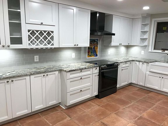 Open-concept kitchen with long run of cabinets is great for storage. Under-cabinet lighting and high hats.