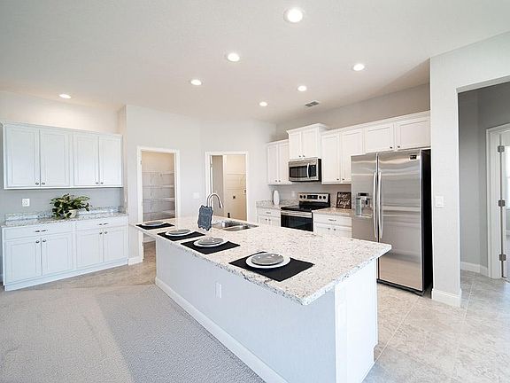 Sunny and open kitchen with ample cabinet and counter space, personalized with your choice of finish