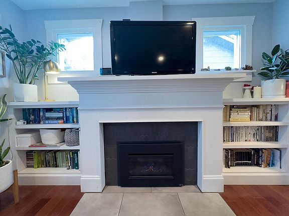 Gas fireplace and built-in bookshelves.