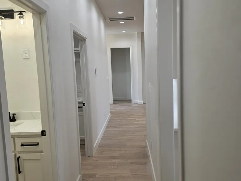 Hallway to main bath, kitchen, great room, and laundry room