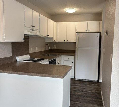 Nice kitchen with plenty of cupboards and a dish washer.