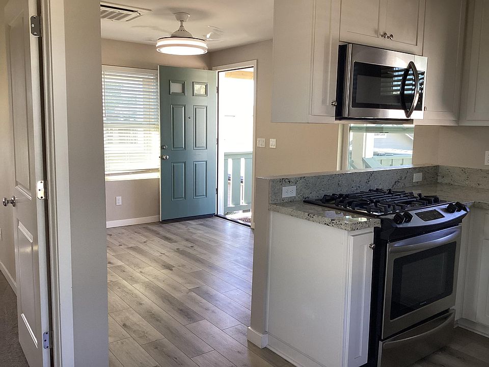 Looking at front door,living room and kitchen from dining nook
