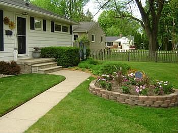 First impressions are important. Walk to the front door, surrounded by groomed, easy-care landscaped