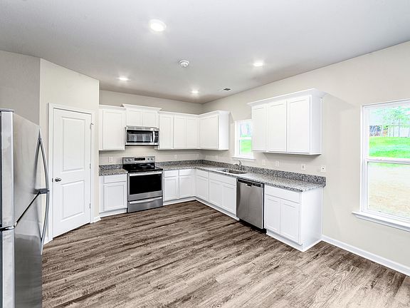 The kitchen is chef-ready with stainless steel appliances