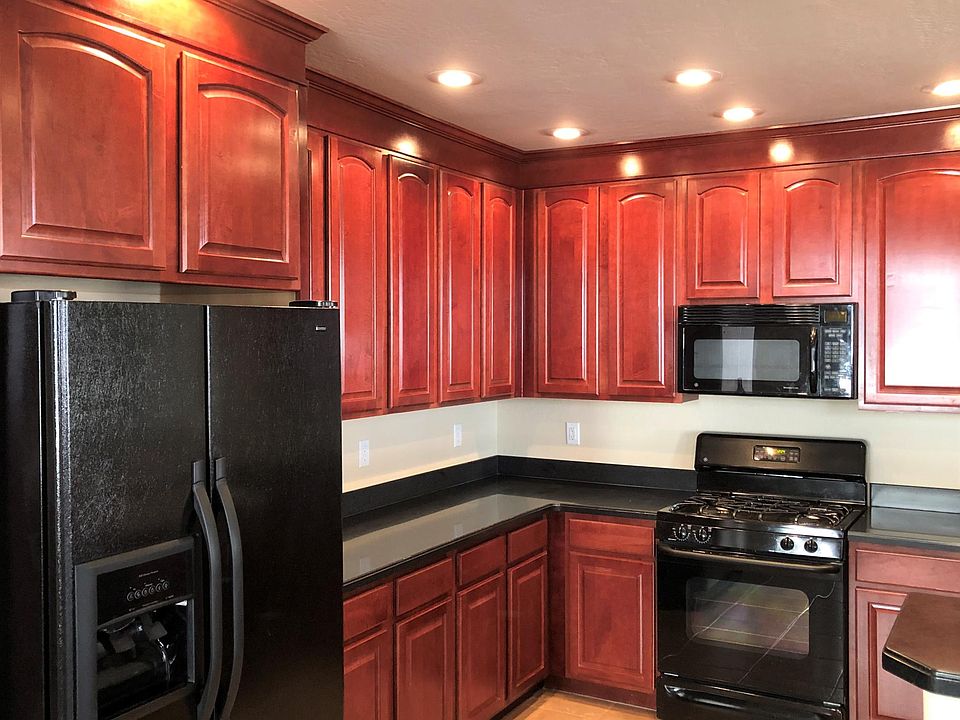 Cherry stained cabinets. Gas range. Corian countertops.