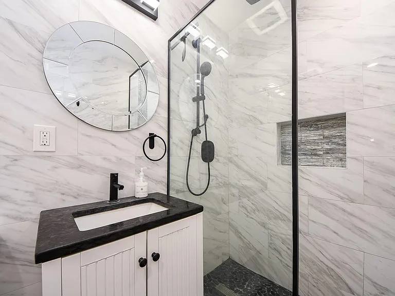 Beautiful light and bright bathroom with black fixtures.