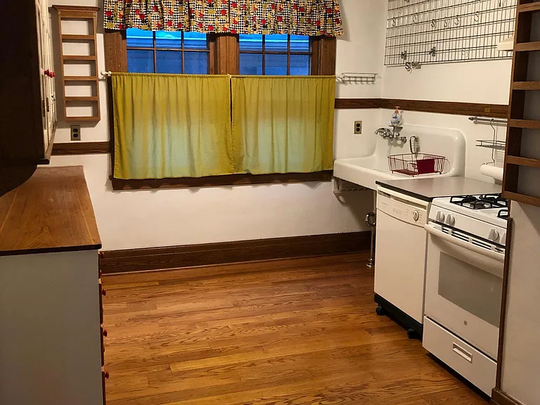 Kitchen with Dishwasher, pot rack, and spice racks.