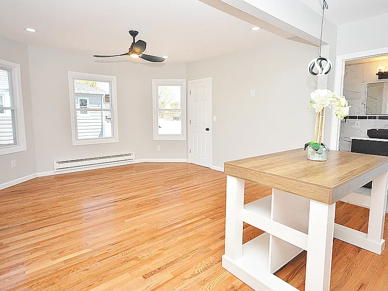Light and airy living room open to the kitchen with new hardwood floors and deep closet for extra storage space.