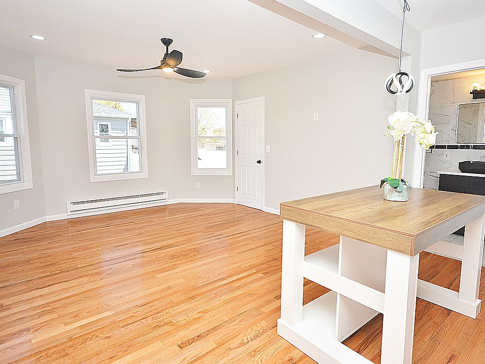 Light and airy living room open to the kitchen with new hardwood floors and deep closet for extra storage space.