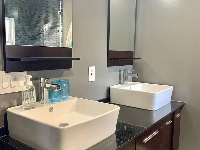 Ensuite bath features dual sinks and large tiled shower.
