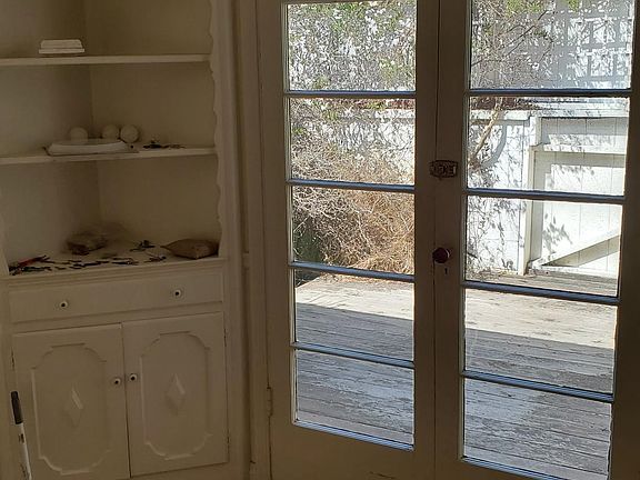 Dining room overlooking outside deck through French doors