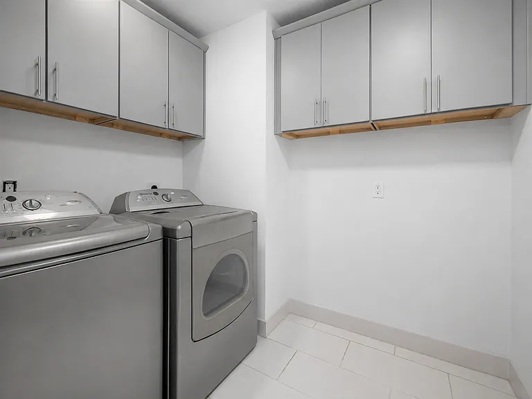 Large laundry room with Samsung washer and dryer with large capacity