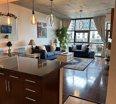 Large kitchen, floor to ceiling windows, 11 foot ceilings, all hardwood and tile flooring, black out curtains for privacy.