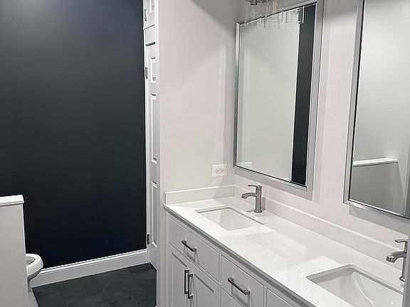 Primary en-suite bathroom, completely remodeled. 6-foot vanity, large linen closet, giant walk-in shower with bench.