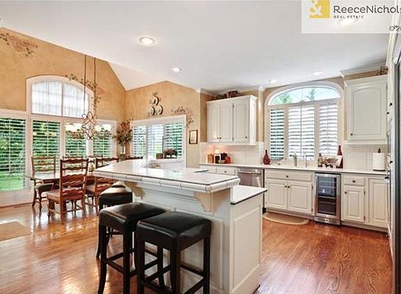 French white cabinets and large center island in the kitchen complete the heart of the home.