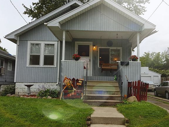 Front with covered porch and cozy swing