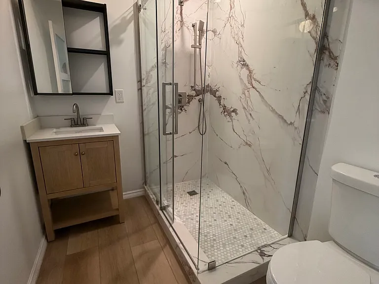 Spa-style bathroom with marble walk-in shower